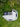 Top view of a 270 awning wall kit on a vehicle, creating a large shaded, enclosed camping area on grassy terrain.
